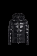 Glossy black puffer jacket on black background